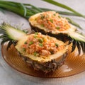 Carved pineapple stuffed with fresh pineapple tomato sauced seafood fried rice Royalty Free Stock Photo