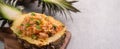 Carved pineapple stuffed with fresh pineapple tomato sauced seafood fried rice Royalty Free Stock Photo