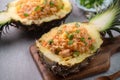 Carved pineapple stuffed with fresh pineapple tomato sauced seafood fried rice Royalty Free Stock Photo