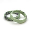 Carved and polished jade bangles. Green oriental gemstone bracelets