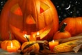 Carved pumpkin with candles Royalty Free Stock Photo
