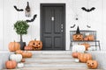 Carved pumpkins on stairs of white house