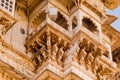 Carved sandstone exterior walls of the udaipur palace with arches, balcony and windows Royalty Free Stock Photo