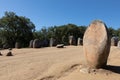 Carved standing stone, menhir, with other megalithic and neolithic standing stones at the Almendres Cromlech near Evora, Portugal Royalty Free Stock Photo