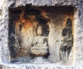 A carved stone Buddha, carved from the rock, Longmen Grottoes an Royalty Free Stock Photo