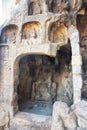 A carved stone Buddha, carved from the rock, Longmen Grottoes an Royalty Free Stock Photo