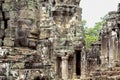 Carved stone face of ancient buddhist temple Bayon in Angkor Wat complex, Cambodia. Cambodian place of interest Royalty Free Stock Photo