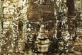 Carved stone faces at ancient temple in Angkor Wat Royalty Free Stock Photo