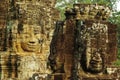 Carved stone faces at ancient temple in Angkor Wat Royalty Free Stock Photo