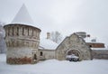 Carved stone gate and tower Fedorovsky town cloudy winter day. Tsarskoye Selo