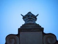 Carved stone Head on top of the Cloth Hall in Krakow Poland