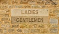 Carved in stone Ladies and Gentlemen sign in The Cotswolds