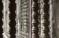 Carved stone pillars typical for Angkor wat temple in Cambodia Royalty Free Stock Photo