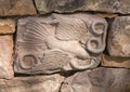 Carved stone relief of an eagle devouring a snake in the wall of a small waterway in Vail Village, Colorado.