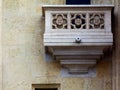 Carved stone sculpted latticework of white building exterior wall detail