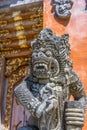 Carved stone sculpture of Dvarapala Guardian at Pura Tirta Empul temple.