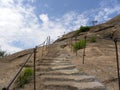 Carved Stone steps with iron railings which leads to the top of mountain peak Royalty Free Stock Photo