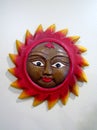 Carved sun face plaque on white wall Royalty Free Stock Photo