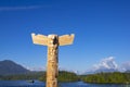 Carved totem pole in the beautiful Tofino with Meares Island in