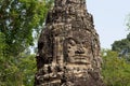 Carved tower bas-relief of Angkor Wat complex temple, Siem Reap, Cambodia. Buddha face stone carving Royalty Free Stock Photo