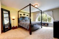 Carved wood bed with high poles. Bedroom interior Royalty Free Stock Photo