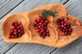 Carved wood tray with array of fresh cranberries