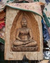 Carved wooden Buddha relief outside wall of the Cosmic Cafe on Oak Lawn in Dallas, Texas.