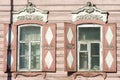 Carved wooden decorative lace decoration windows. Old wooden house.