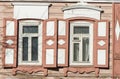 Carved wooden decorative lace decoration windows. Old wooden house.