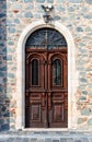 Carved wooden door in a stone wall Royalty Free Stock Photo