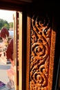 Carved wooden door Thai art pattern With the shining sunlight