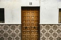 Carved wooden door and tiled wall