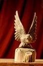 The carved wooden eagle froze in the wingspan