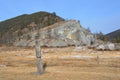 Carved wooden pagan figure on Cape Bolshoy Kadilnyy in the winter. Baikal lake, Russia