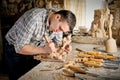 Carver working with plane in art studio