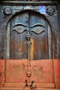 Carving art wooden eyes of wisdom buddha on antique wood door in ancient nepalese architecture and antique old ruin nepali royal