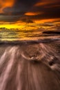 Carving the beach with smooth waves and sunsets Royalty Free Stock Photo