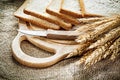 Carving board kitchen knife sliced bread rye ears on hessian bac Royalty Free Stock Photo