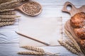 Carving board wheat rye ears bread stick wooden spoon corn vinta Royalty Free Stock Photo