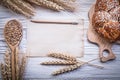 Carving board wheat rye ears bread stick wooden spoon grain vint Royalty Free Stock Photo