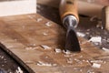 Carving chisel on workbench with wood chips Royalty Free Stock Photo