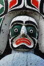 Carving face on totem pole Royalty Free Stock Photo