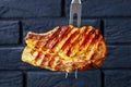 Carving fork with speared grilled pork chop