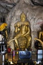 Carving stone and sculpture buddha image statue on cave wall for thai people travel visit respect praying blessing mystical at