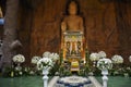 Carving stone and sculpture rock buddha image statue on stone wall for thai people travel visit respect praying blessing worship