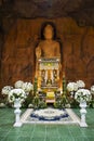 Carving stone and sculpture rock buddha image statue on stone wall for thai people travel visit respect praying blessing worship