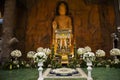 Carving stone and sculpture rock buddha image statue on stone wall for thai people travel visit respect praying blessing worship