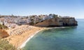 Elevated view of tourists and locals enjoying Carvoeiro beach and town