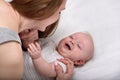 Carying Loving mom of her newborn. Baby smiles, happy motherhood concept