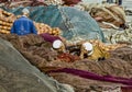 Men lying on fishing nets and discuss